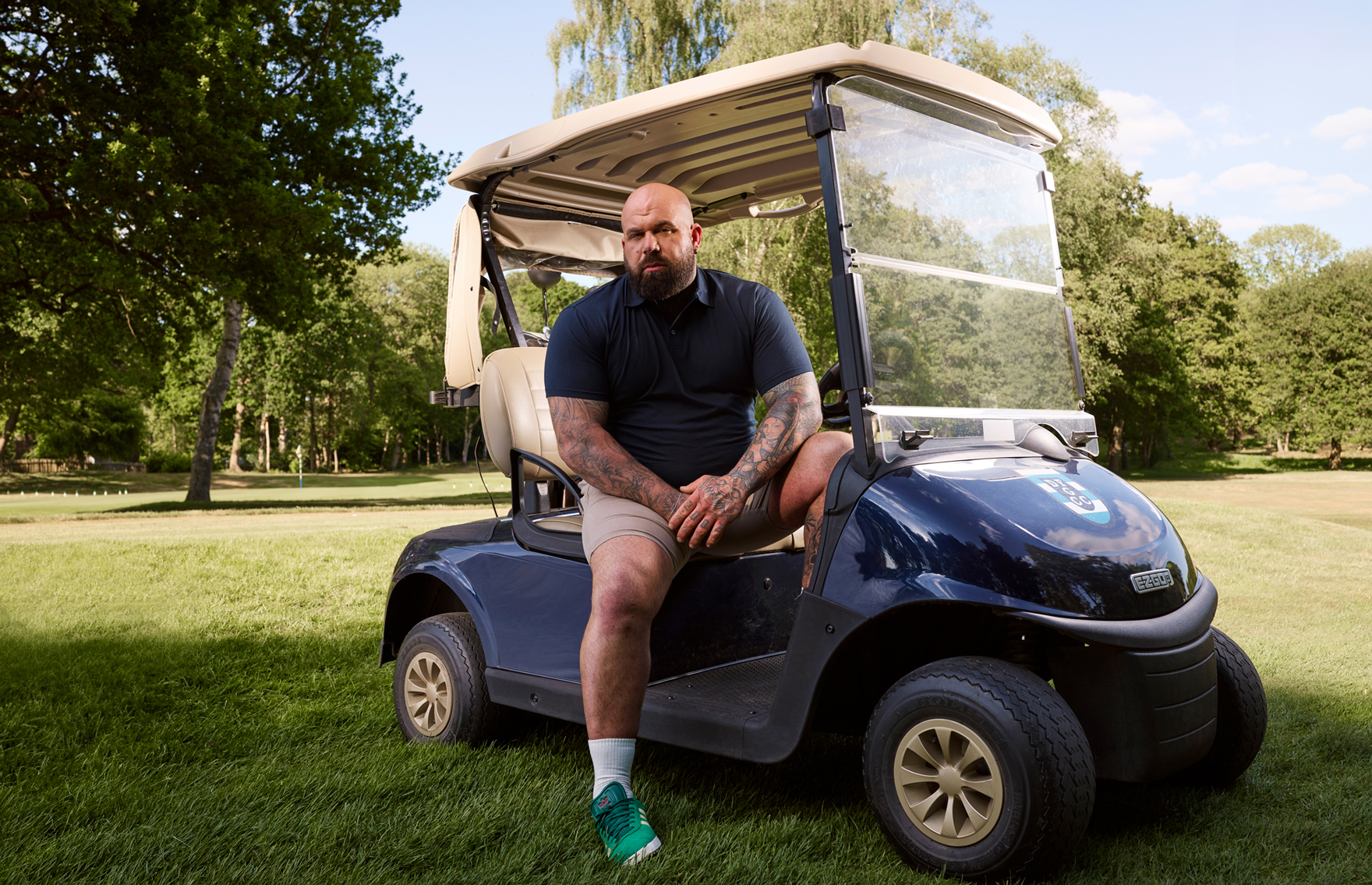 Plus sized man in golf buggy