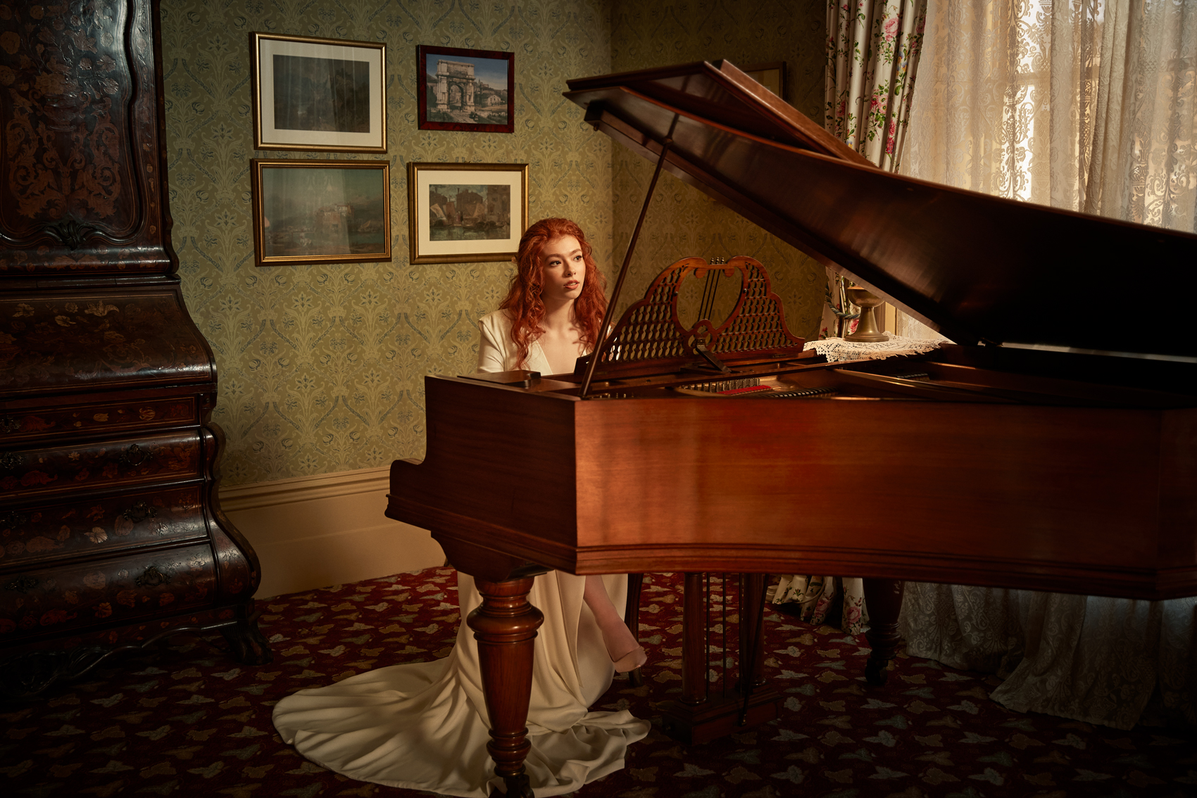 Beautiful red haired bride plays piano